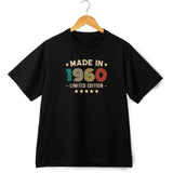 Black t-shirt with 'Made in 1960' text on a hanger against a white background