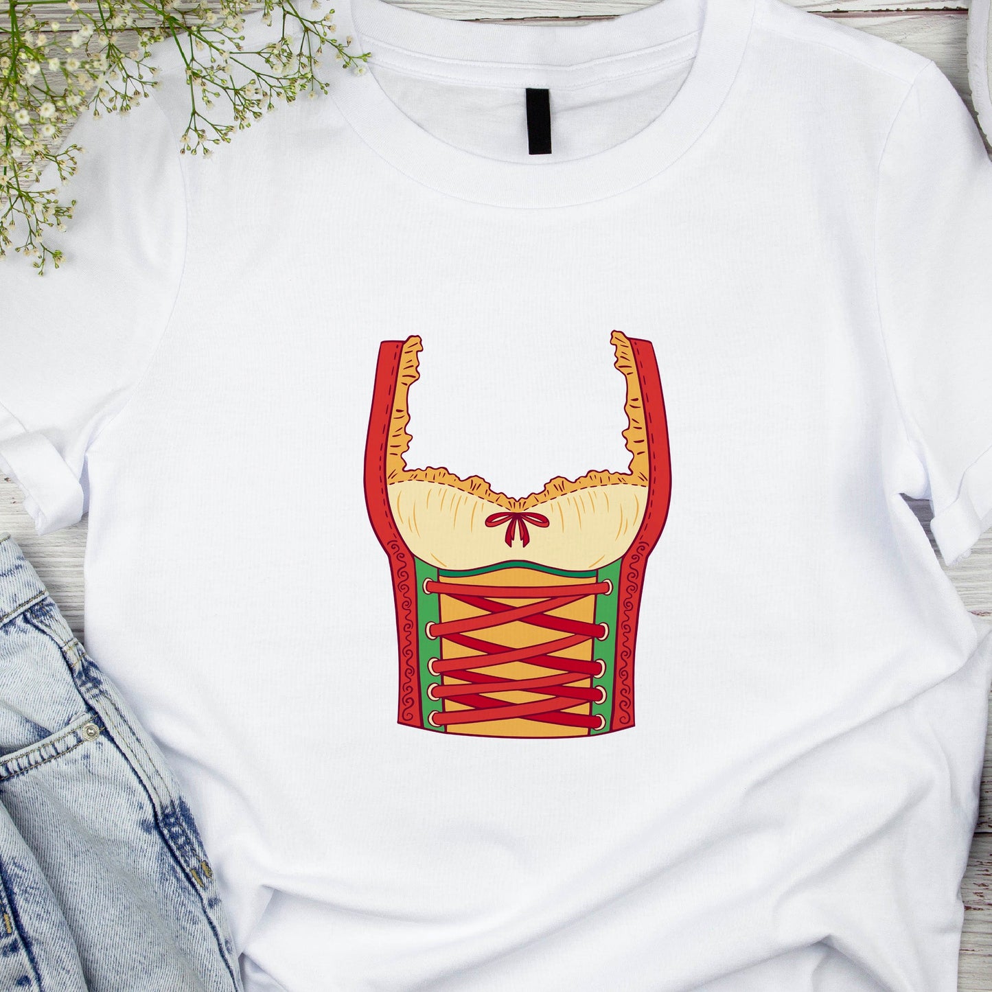 White t-shirt with a graphic design of a corset on a wooden surface.