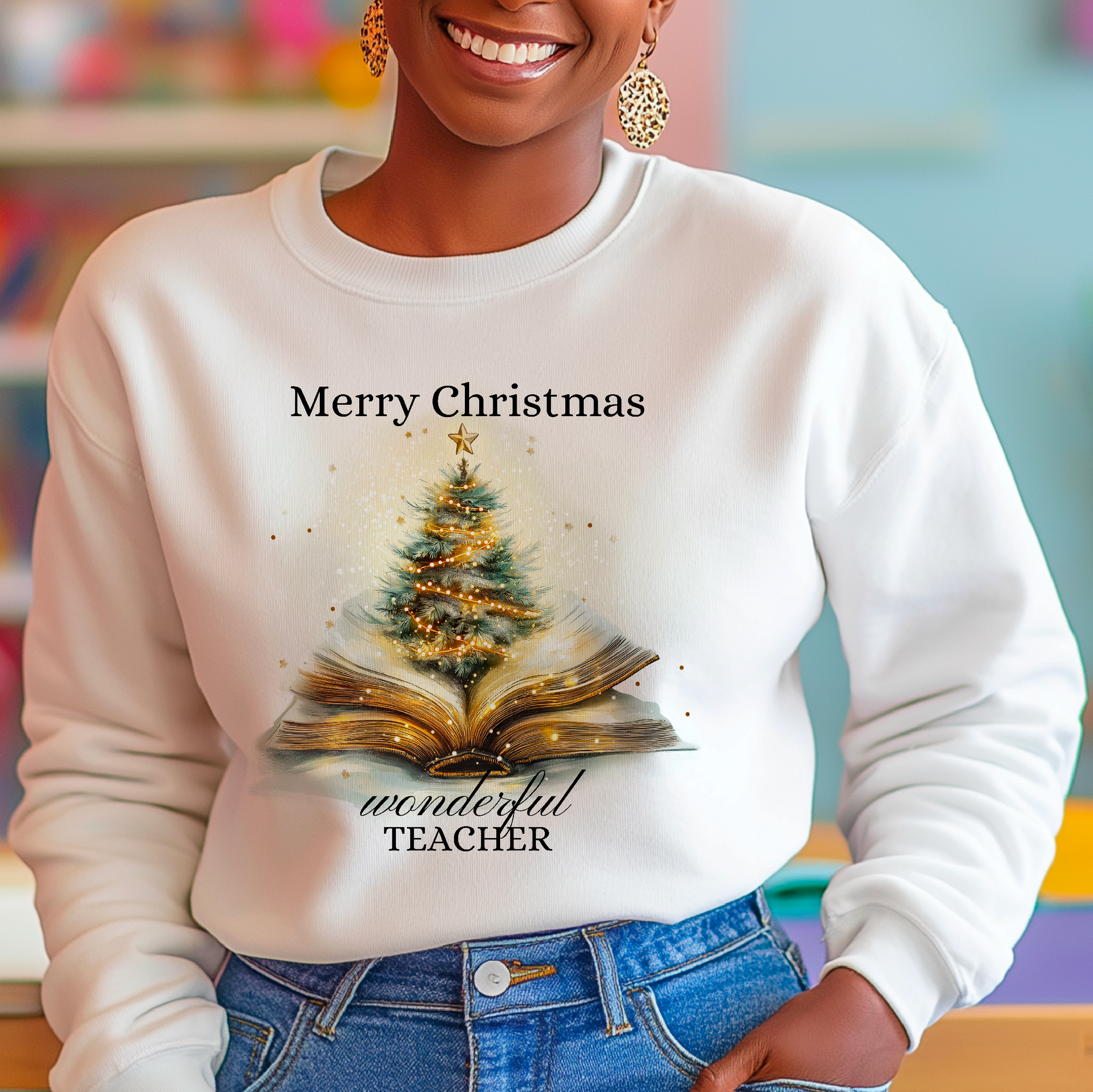 A person wearing a white sweatshirt with 'Merry Christmas' and 'Wonderful Teacher' text, along with an image of a Christmas tree.